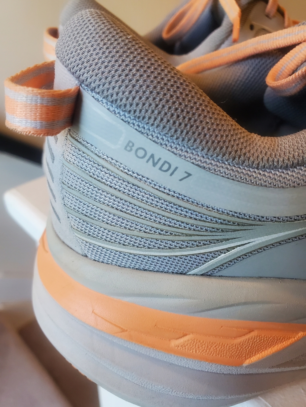 HOKA Bondi 7 running shoes in a clean gray & peach colorway - Picture 4 of 7